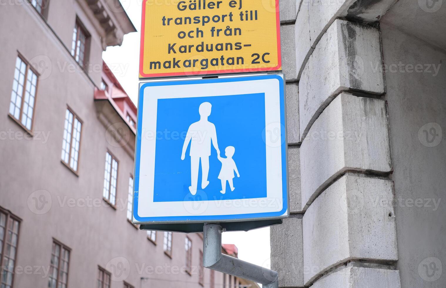 A sign with a man and a child walking on it. photo