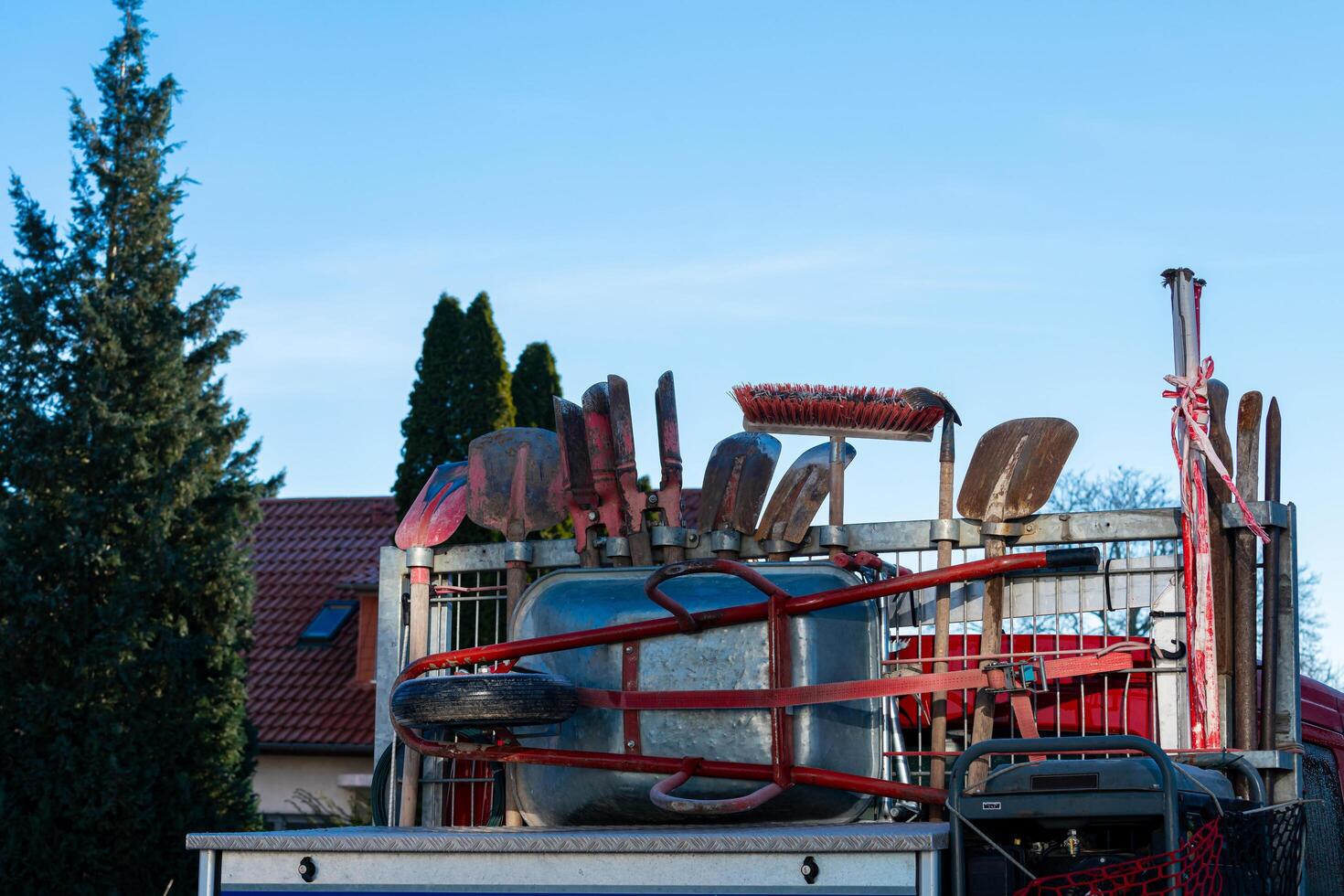 Garden tools and equipment loaded on a trailer in daylight photo