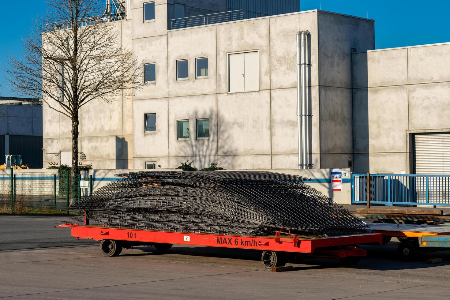 Steel reinforcement stack on a red cart at an industrial location photo