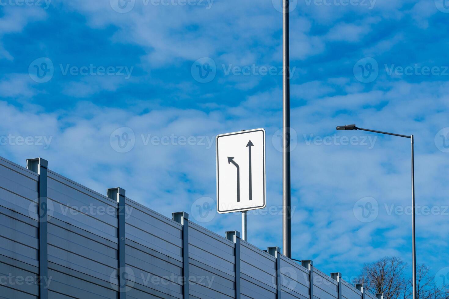 Traffic sign indicating left and right turns on a highway photo