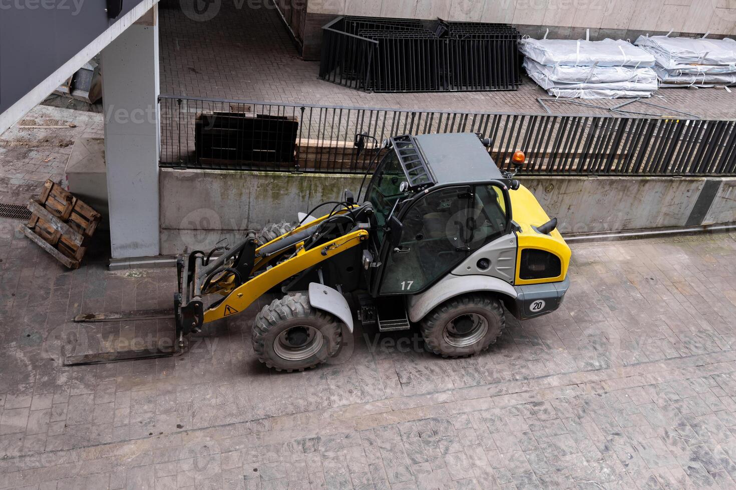 Yellow construction forklift stands on construction site. Top view. photo