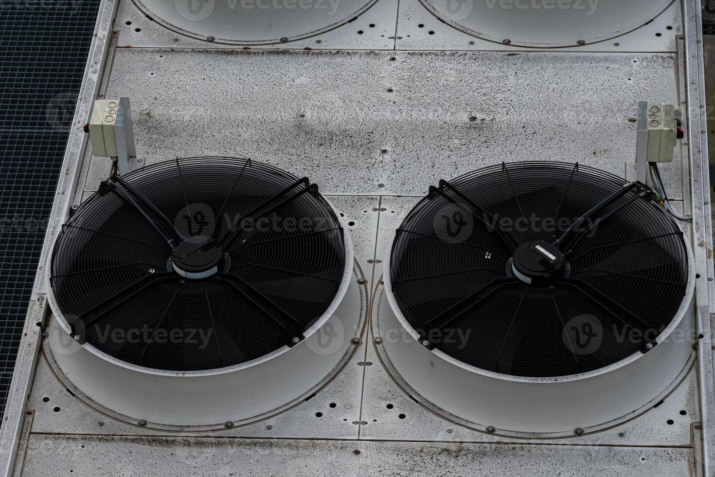 Rooftop cooling units on a commercial building in a city photo