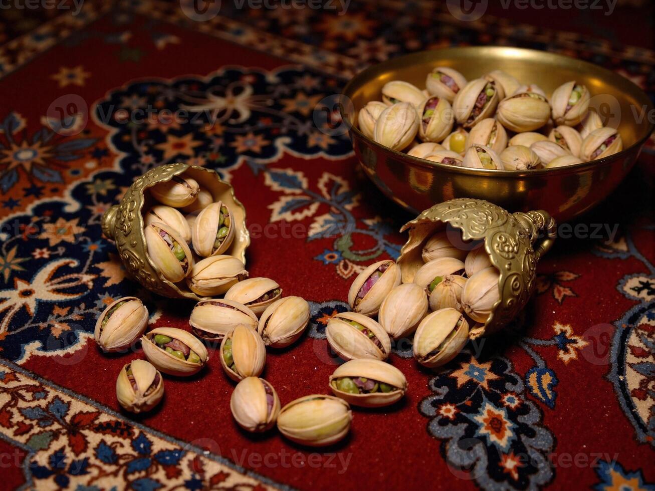 Pistachios in a bowl on a rug photo