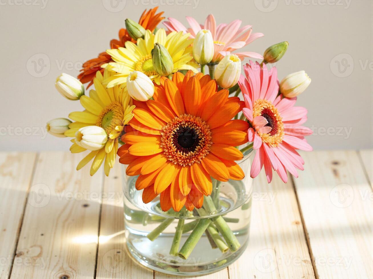A vase filled with colorful flowers on a wooden table photo