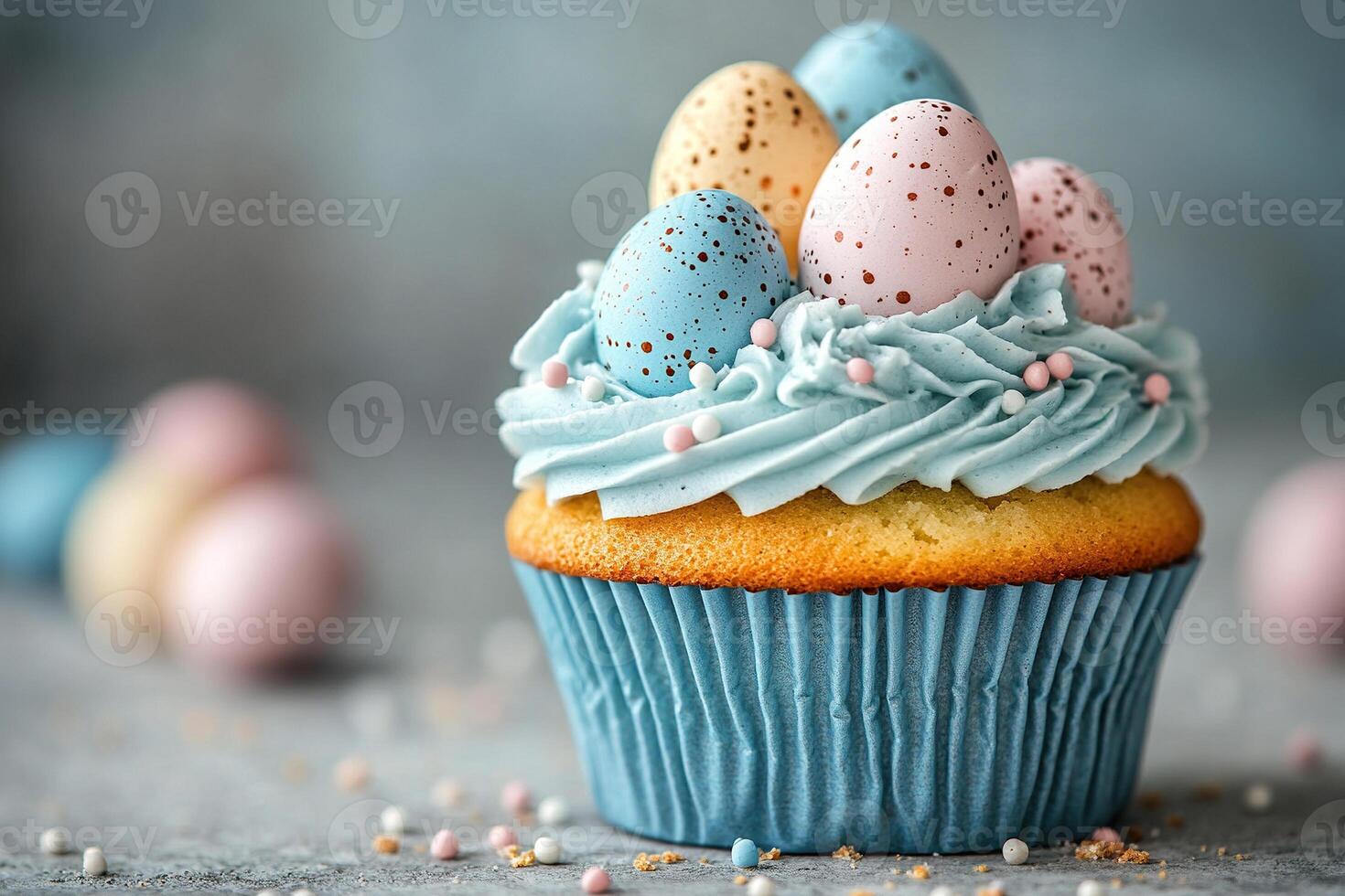 Vanilla cupcake with cream and sweet quail egg decoration stands on a table with a blurred blue background. photo