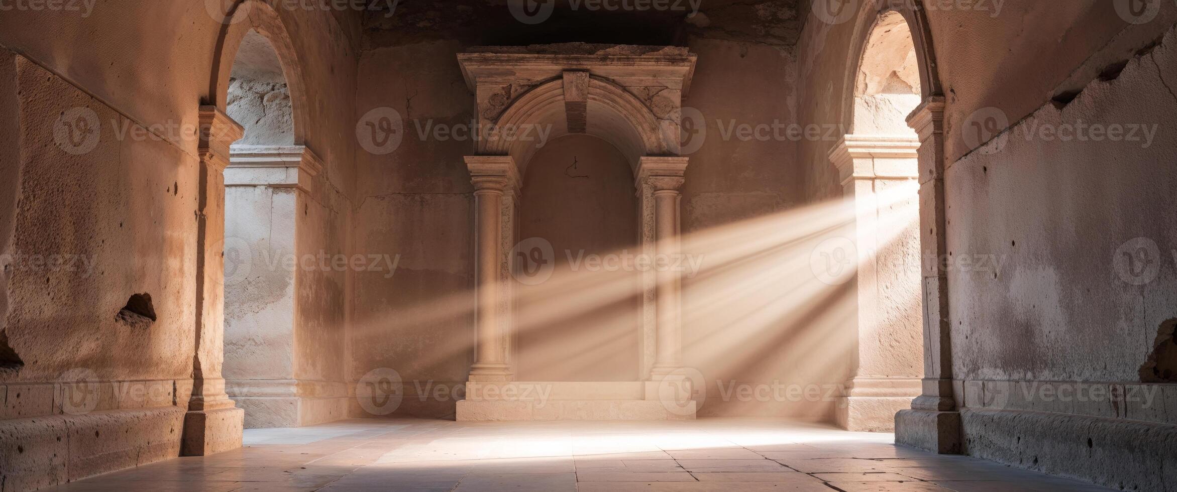 Empty stone tomb illuminated by shafts of light from the entrance photo