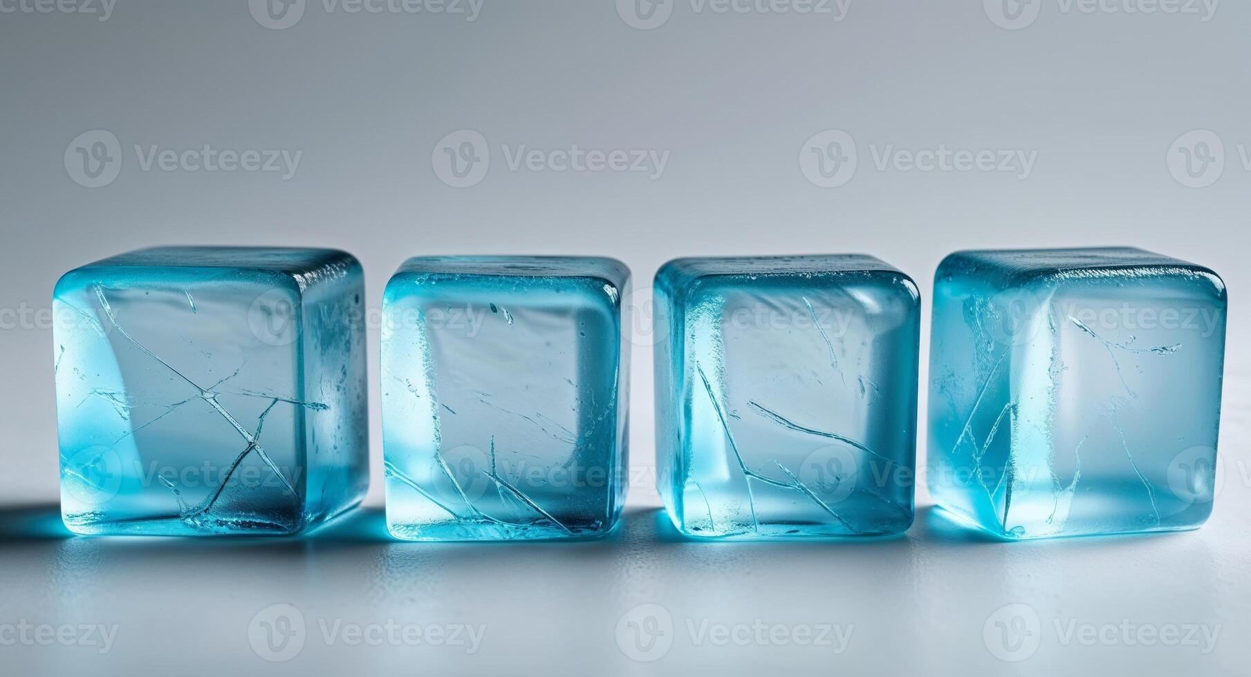 Three blue ice cubes sitting on a table photo