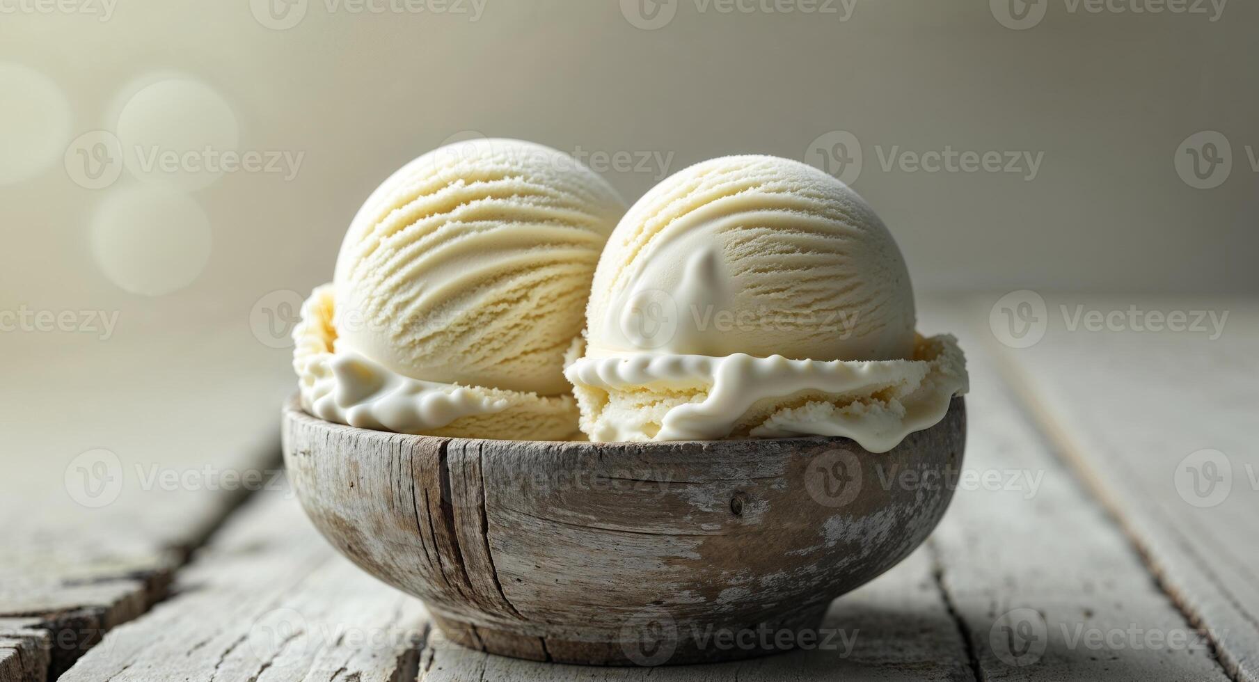 Creamy vanilla ice cream scoops in a rustic wooden bowl on a neutral colored surface background photo