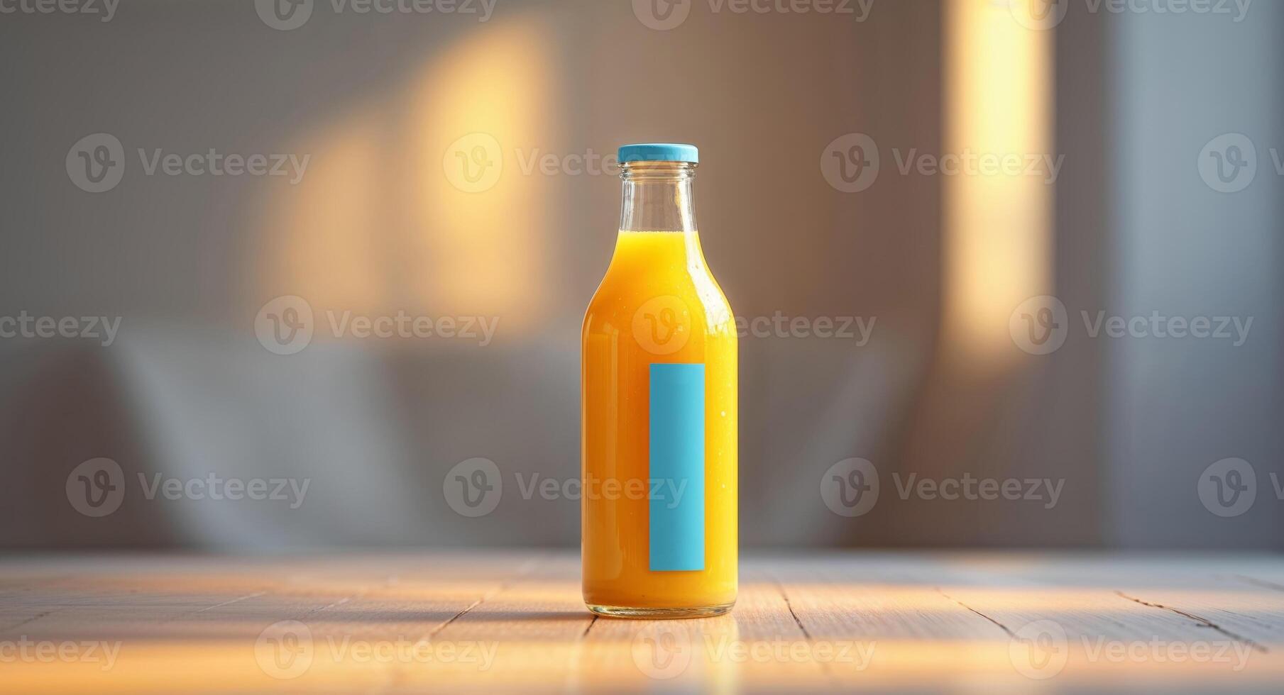 Bottle of orange juice is sitting on a table indoors with the background out of focus. photo
