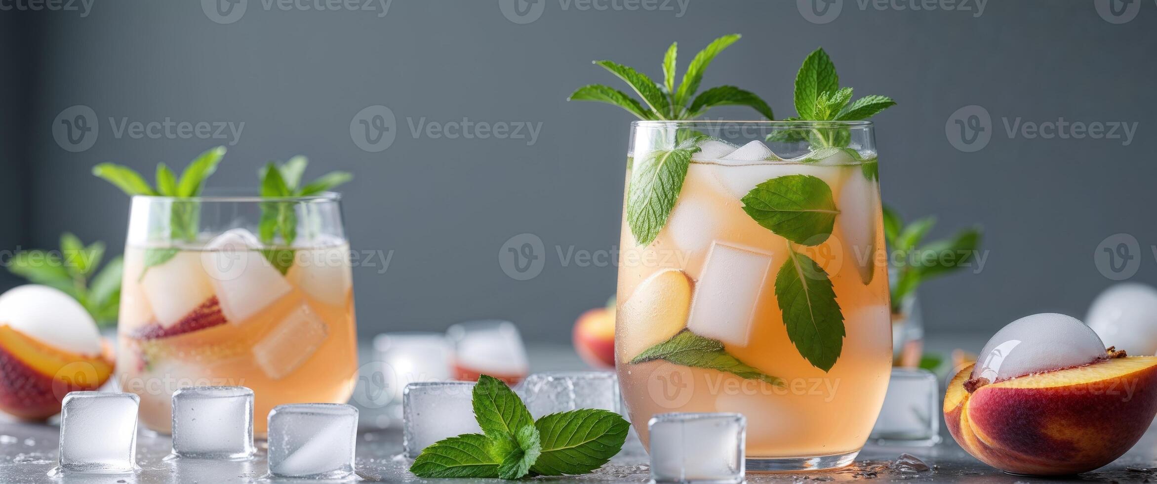 Refreshing Peach Iced Tea with Mint and Ice Cubes on a Dark Surface photo