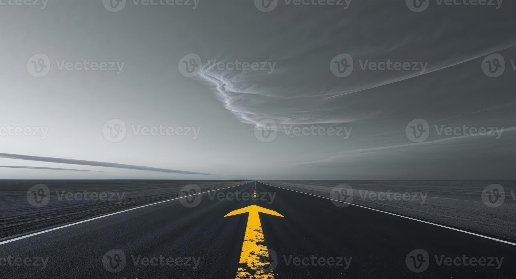 An empty road with a yellow arrow pointing to the sky photo