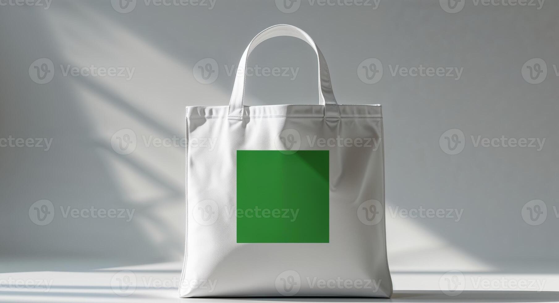 A white shopping bag with a green square on it photo
