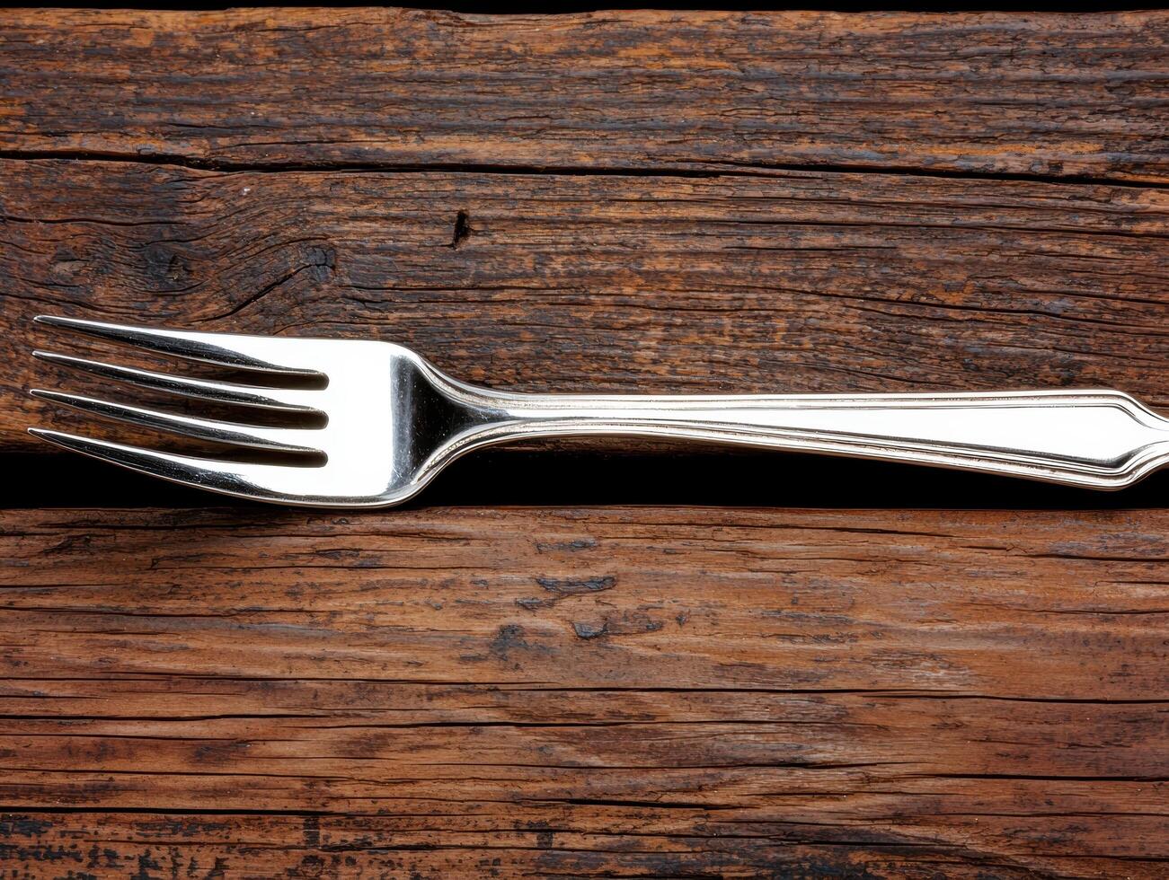 Silver fork on a rustic wooden table photo