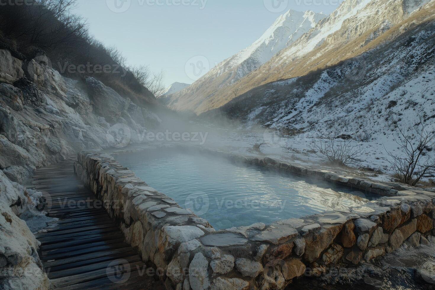 Hot spring in a snowy mountain valley photo
