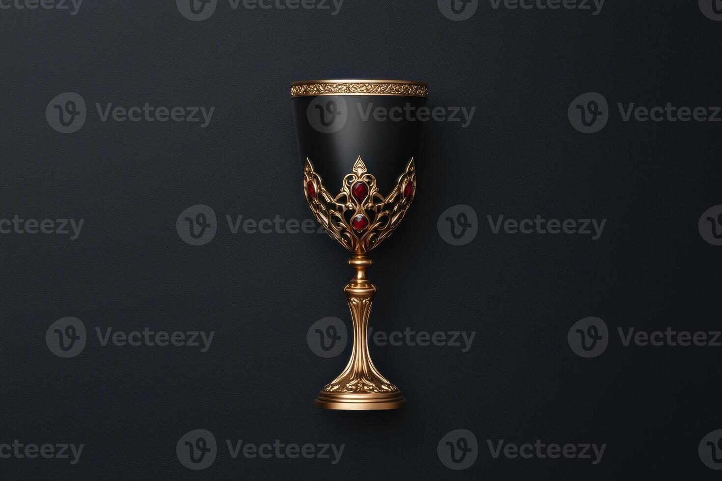 Ornate black and gold goblet with red gems on a dark background photo