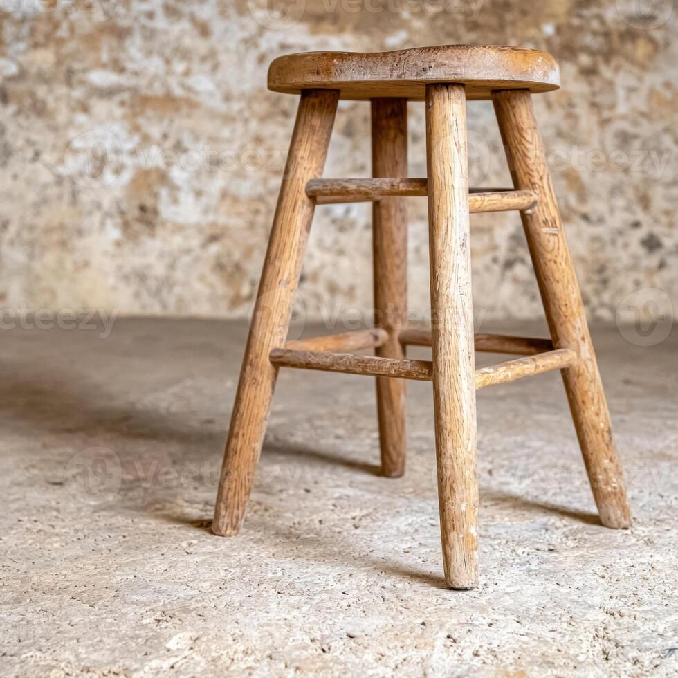 Rustic wooden stool in a room with textured walls photo