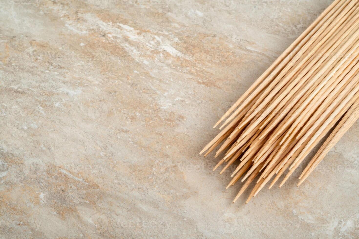 Bamboo skewers on a textured surface photo