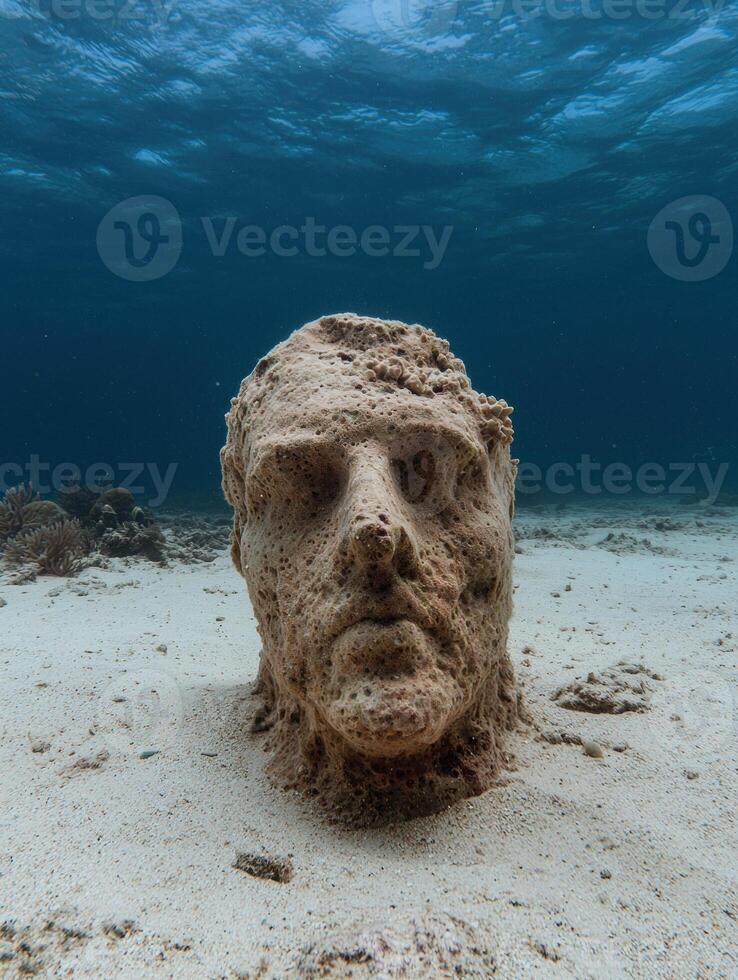 Underwater sculpture of a human head on the seabed photo