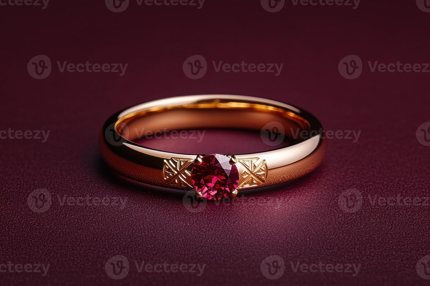 Elegant gold ring with a ruby gemstone on a dark background photo