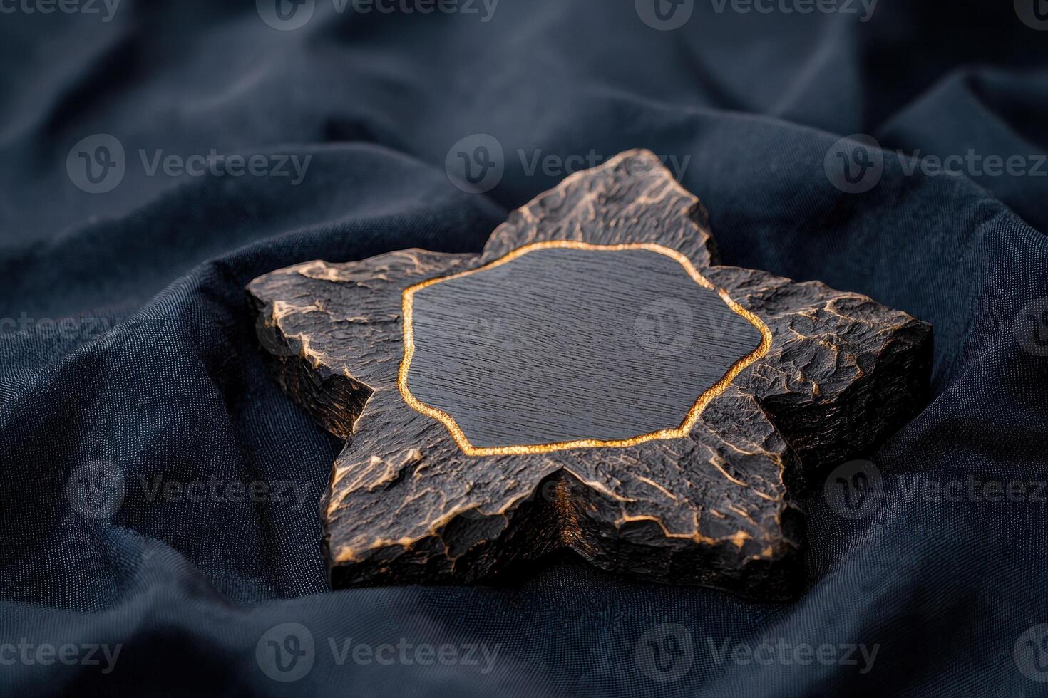 A decorative star shaped object with a gold trim on a blue fabric background photo