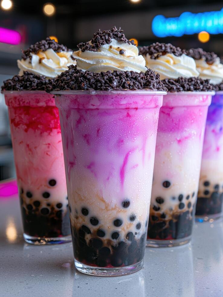 Colorful bubble tea drinks with tapioca pearls, whipped cream, and chocolate sprinkles photo