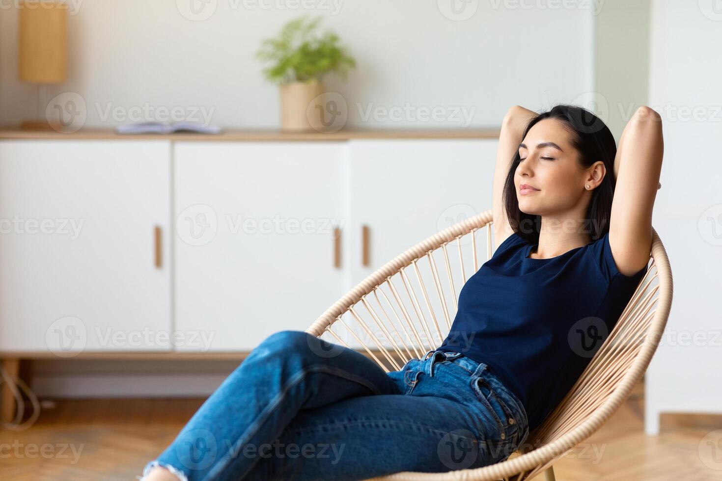 Enjoy Weekend. Girl Relaxing Holding Hands Behind Head Sitting In Cozy Chair With Eyes Closed Resting At Home. Free Space photo