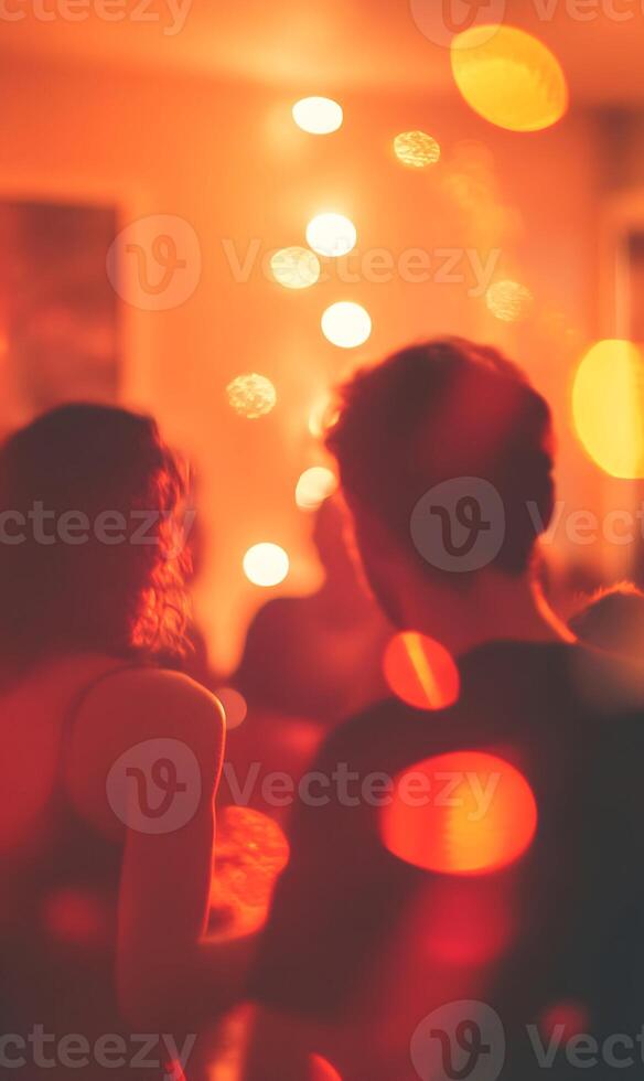 Vibrant social gathering captured with warm lighting and festive bokeh effects creating intimacy photo