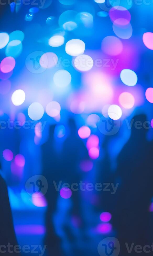 Crowd Silhouettes Immersed in a Dazzling Display of Blue and Violet Bokeh Lights photo