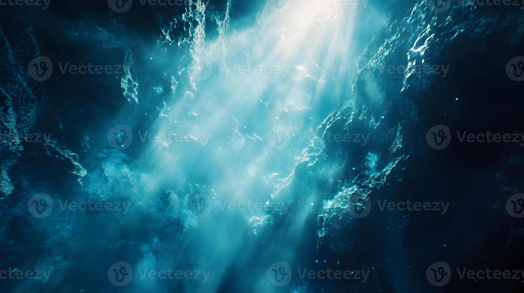 Dramatic Underwater Cave Scene with Light Rays Penetrating Turquoise Water Surface photo