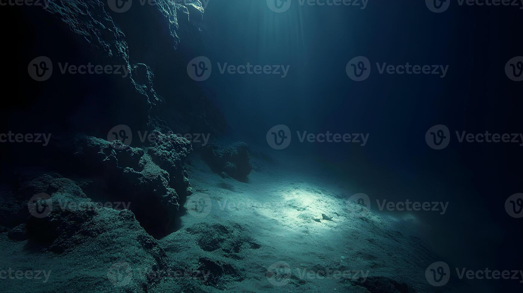 Underwater scene depicting a deep sea cave with sun rays penetrating the surface photo