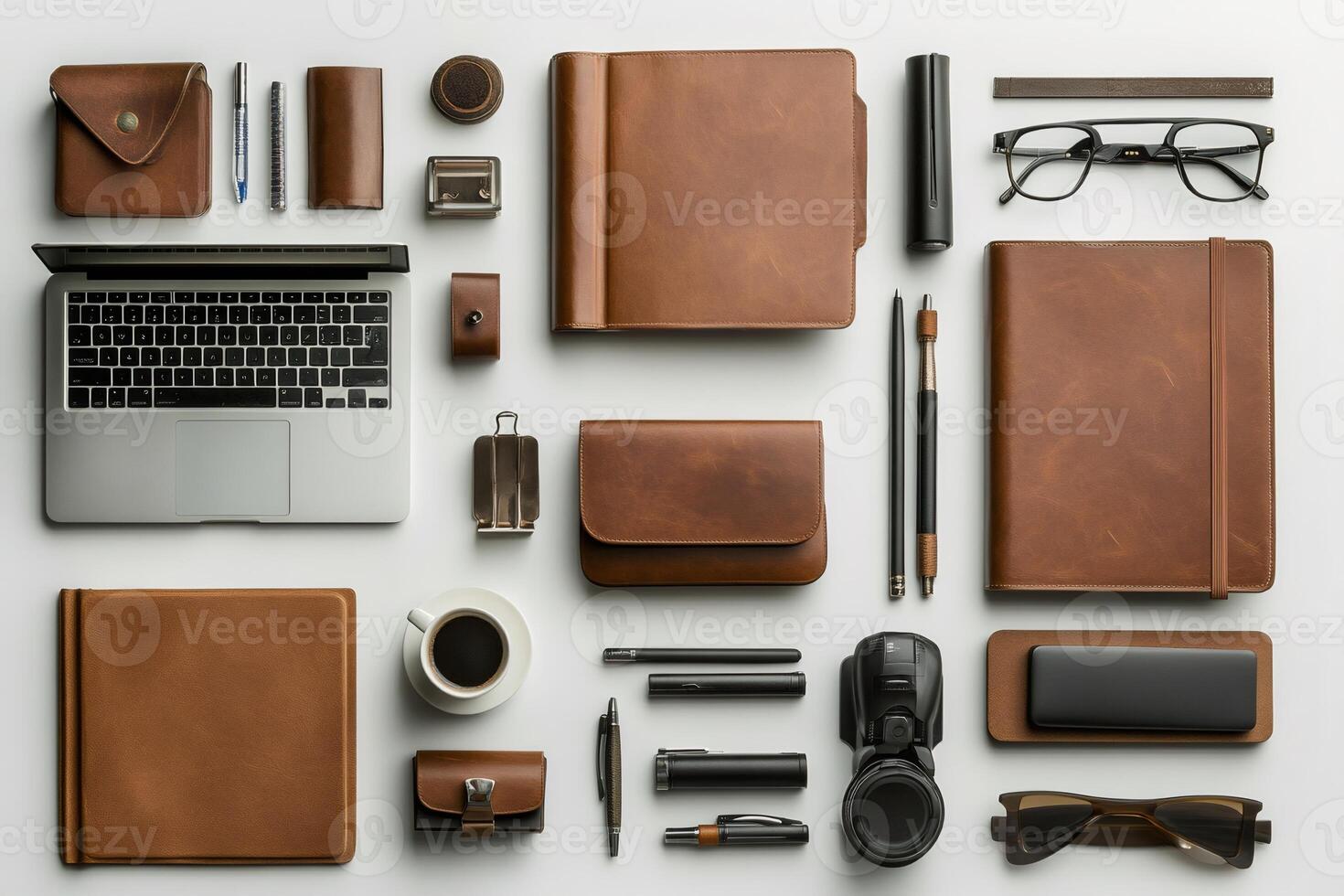 Modern workspace showing laptop, notebooks, pens, glasses, coffee and various accessories on white background photo