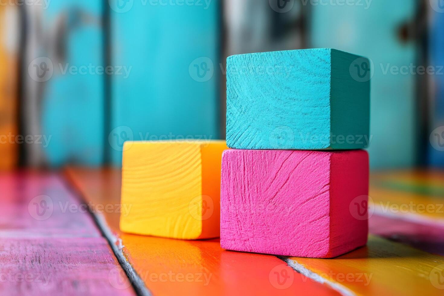 Colorful wooden cubes resting on a vibrant wooden surface photo