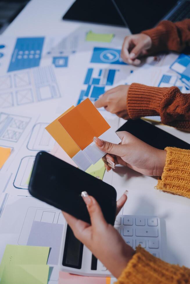 A group of people working on a project with paper and other materials photo