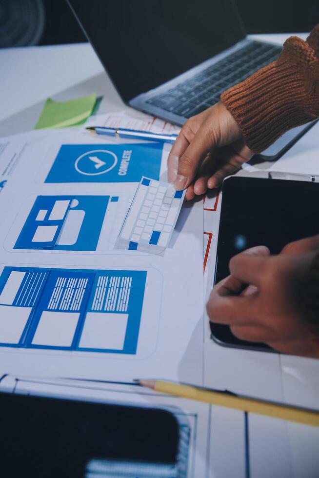 A person is working on a laptop with a blue and white design photo