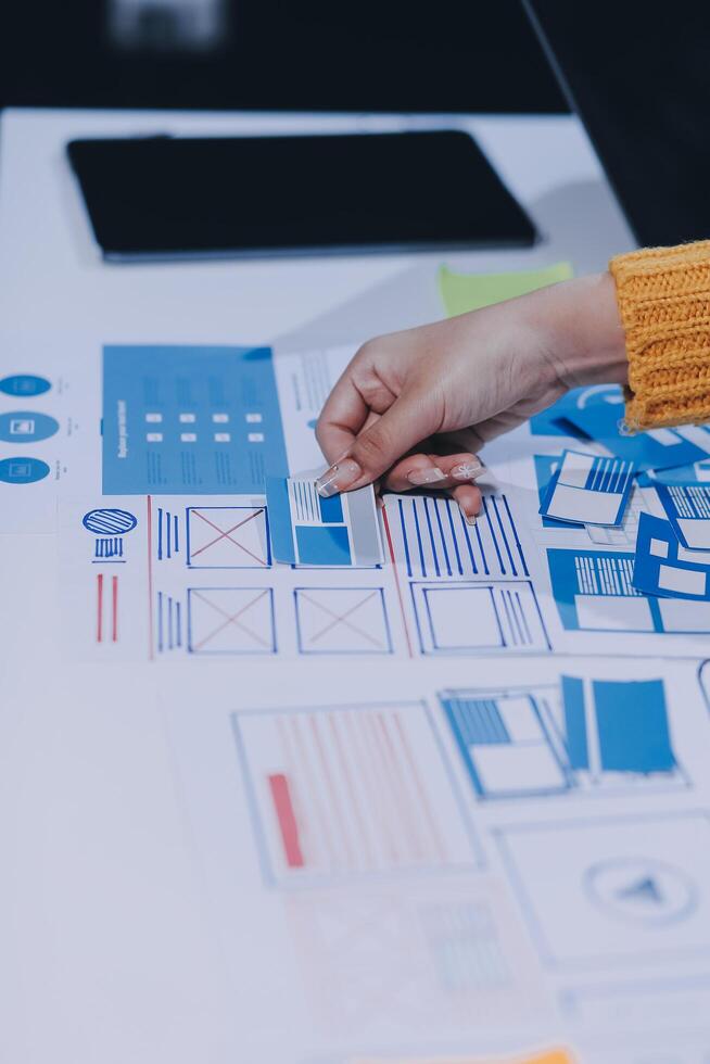 A person is working on a design project on a table photo