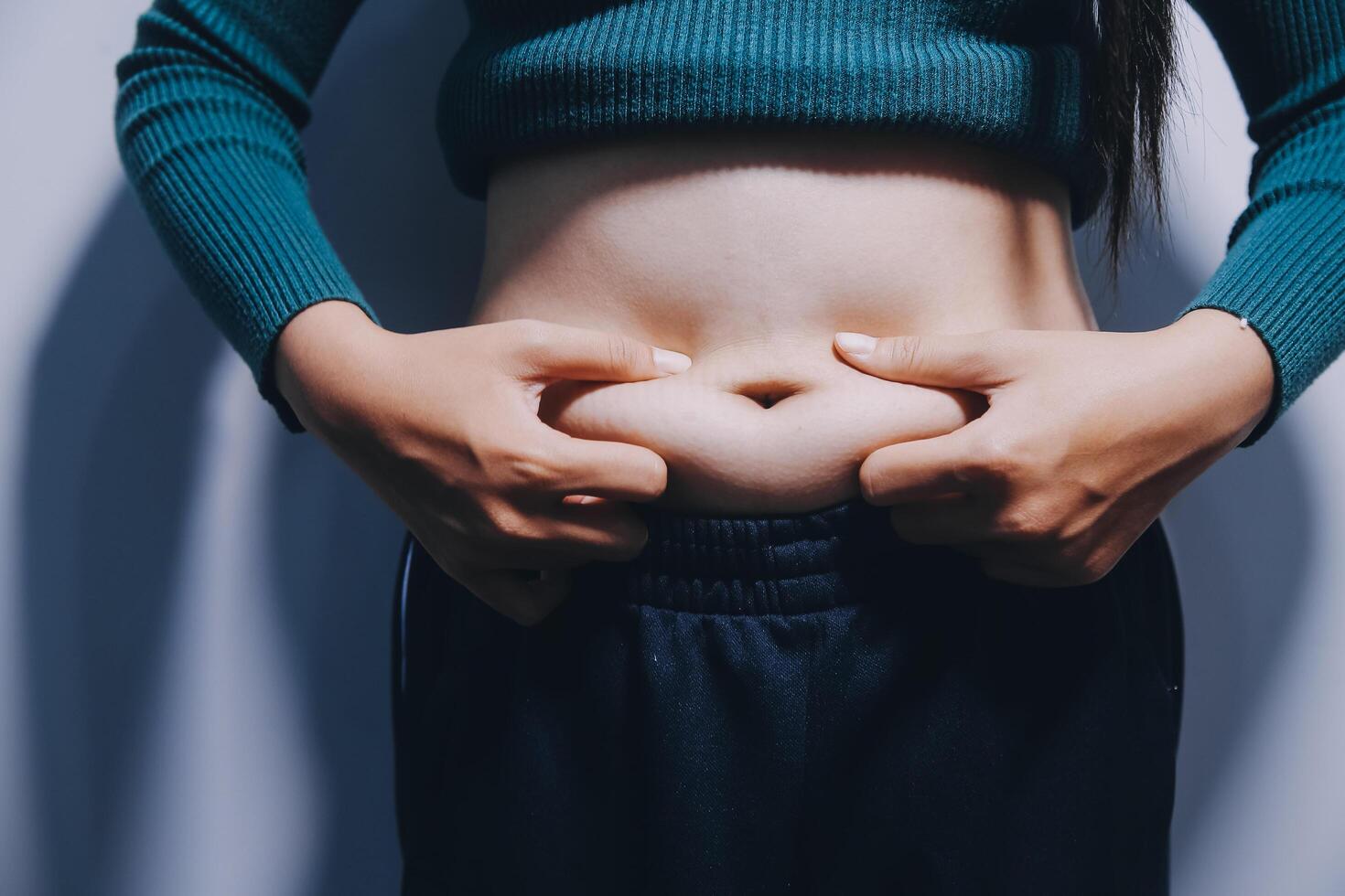 A woman with her hands on her stomach photo