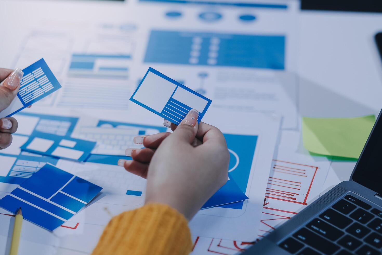 A person is holding a piece of paper with blue and white design on it photo