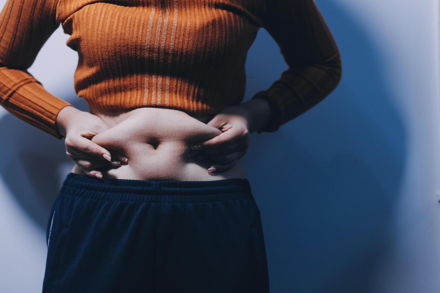 A woman with her hands on her stomach photo