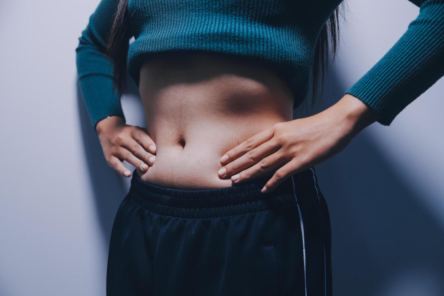 A woman with her hands on her stomach photo