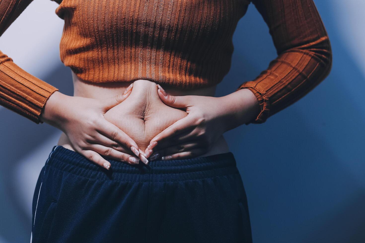 A woman with her hands on her stomach photo