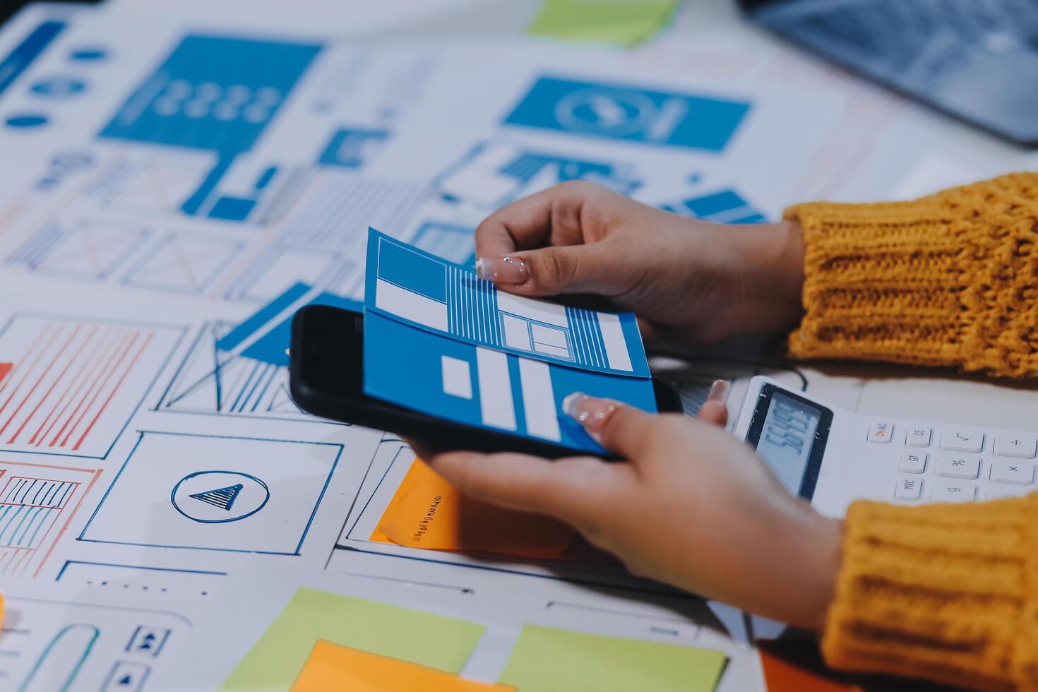 A person is using a smartphone to view a design photo