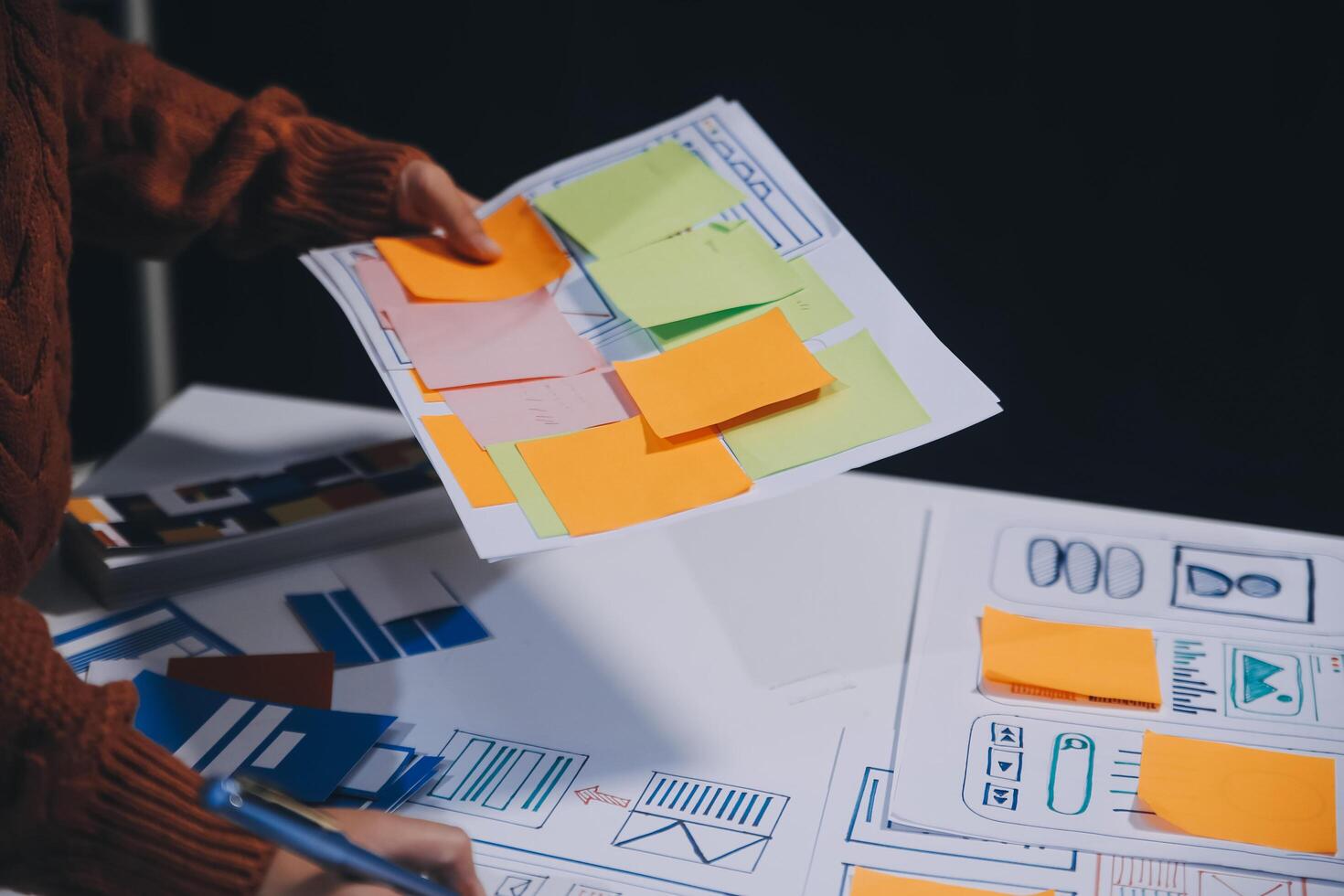 A person is holding a piece of paper with sticky notes photo