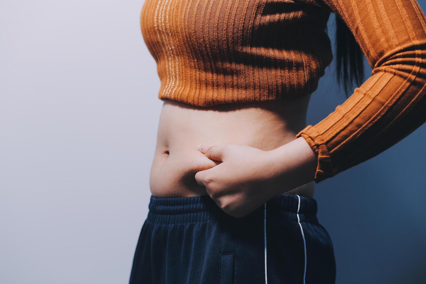 A woman with her hands on her stomach photo