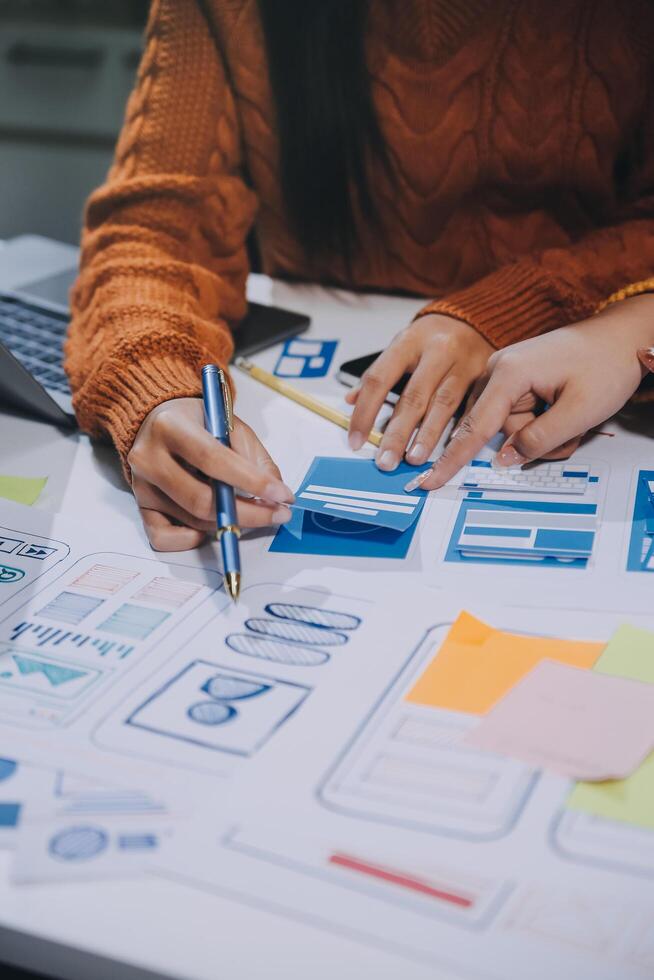 A woman is working on a design project with a laptop photo
