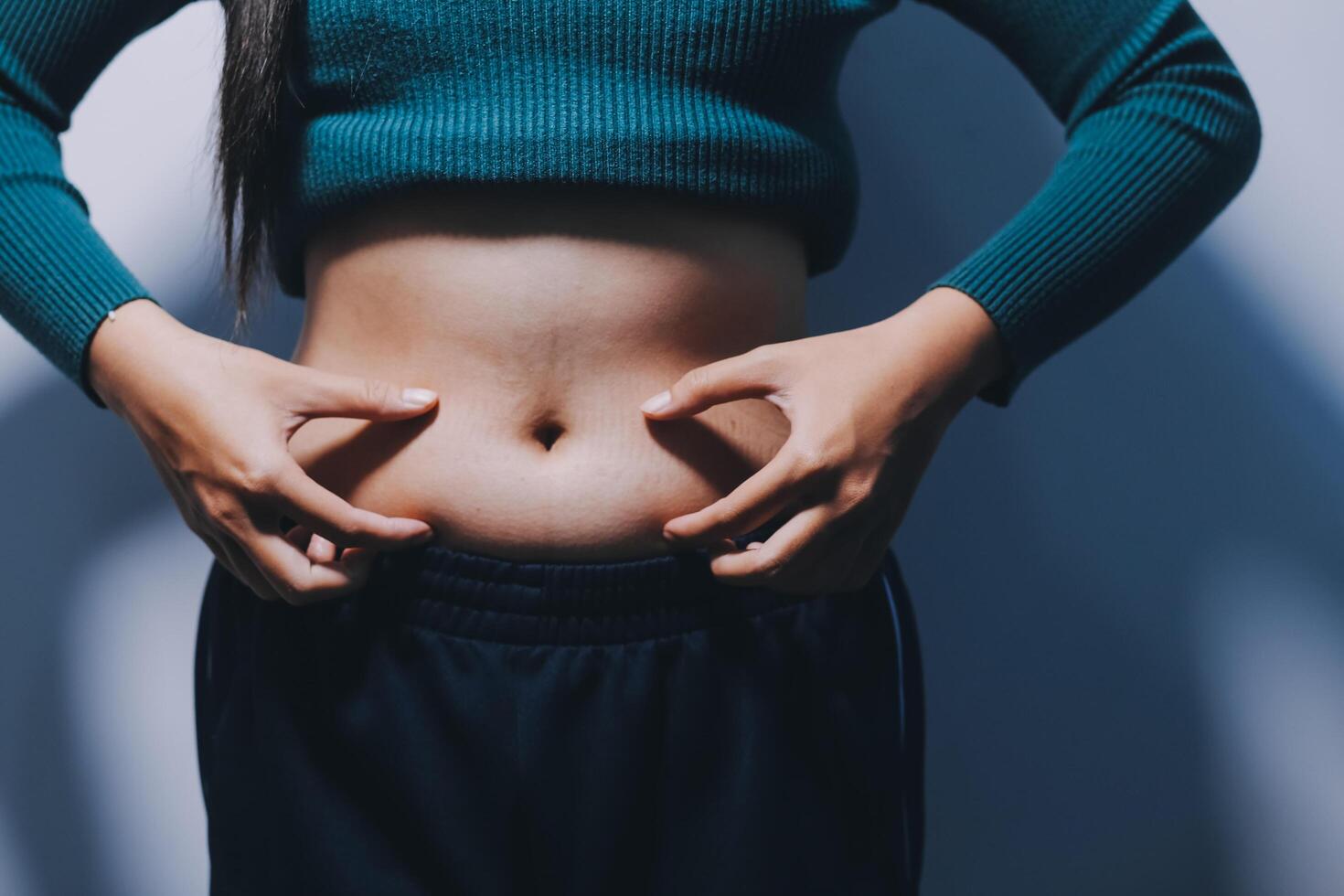 A woman with her hands on her stomach photo
