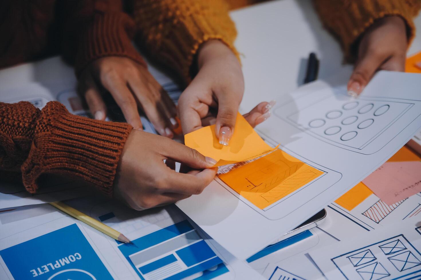 People working on a project with paper and pencils photo