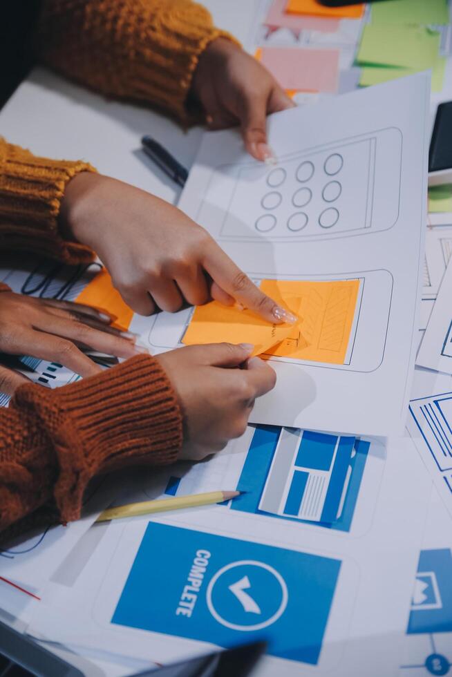 A group of people working on a project with paper and other items photo