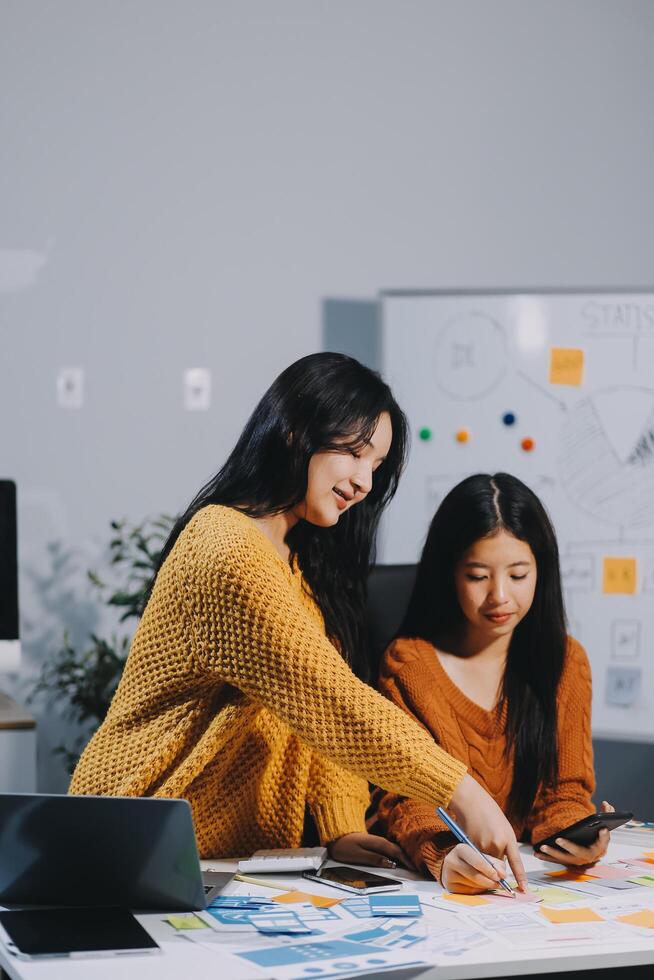 Two women working on a project together in an office photo