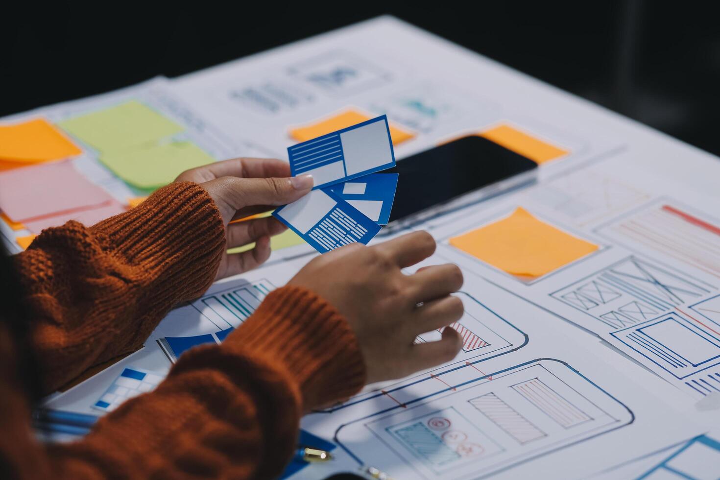 A person is working on a project with sticky notes photo