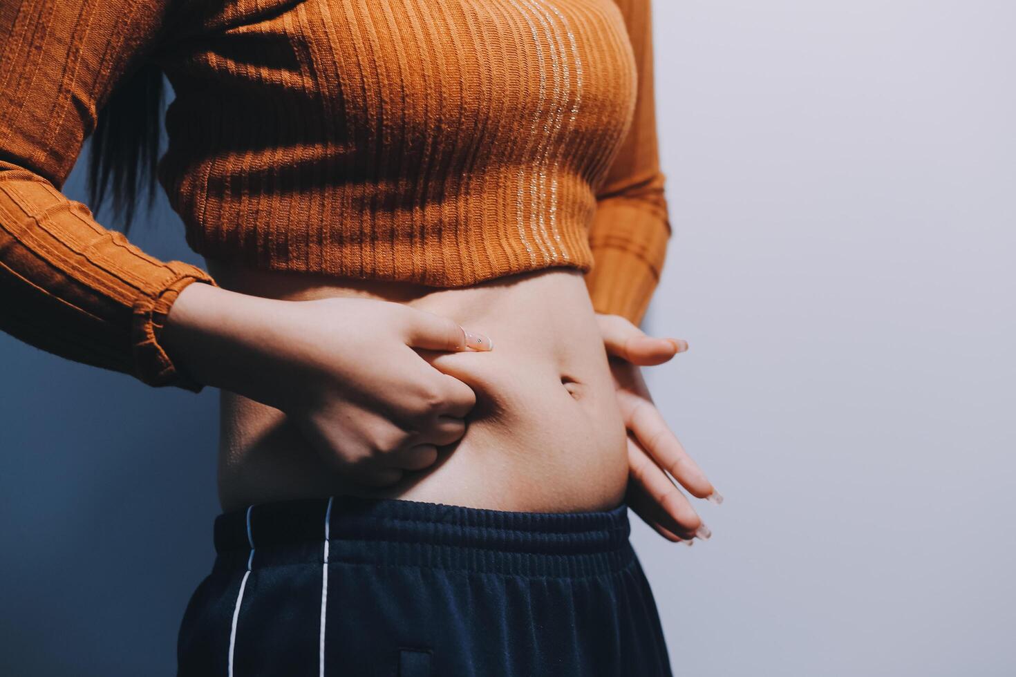 A woman is holding her stomach photo